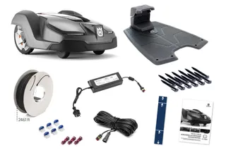 Husqvarna robotic lawn mower with charging station, boundary wire, and installation accessories.