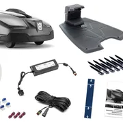 Husqvarna robotic lawn mower with charging station, boundary wire, and installation accessories.