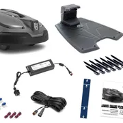 Husqvarna robotic lawn mower with accessories including charging station, boundary wire, and connectors.