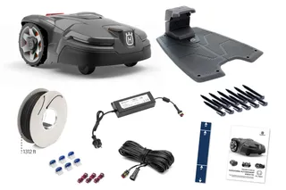 A set of Husqvarna robotic lawn mower accessories including a charging station, boundary wire, connectors, and installation guide.