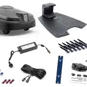 A set of Husqvarna robotic lawn mower accessories including a charging station, boundary wire, connectors, and installation guide.