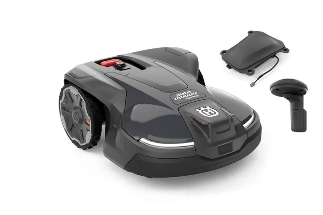 Front view of a Husqvarna robotic lawn mower with accessories.