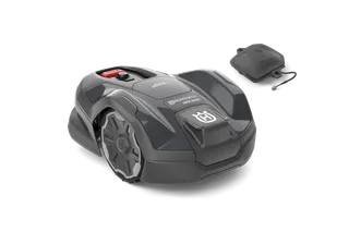 Side view of a Husqvarna robotic lawn mower with a charging station.