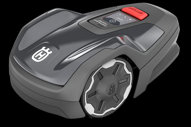 Side view of a Husqvarna Automower® Aspire™ R4 robotic lawn mower with visible control panel.