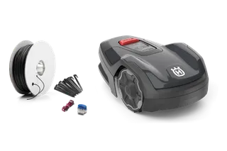 Husqvarna robotic lawn mower with installation kit including boundary wire and connectors.