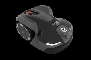 Side view of a Husqvarna robotic lawn mower on a white background.