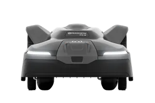 Front view of a Husqvarna robotic lawn mower with LED headlights.