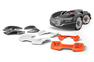 Kosiarka automatyczna Husqvarna z wymiennymi osłonami w różnych kolorach.