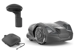 Husqvarna robotic lawn mower with a charging station and a protective cover, studio shot.