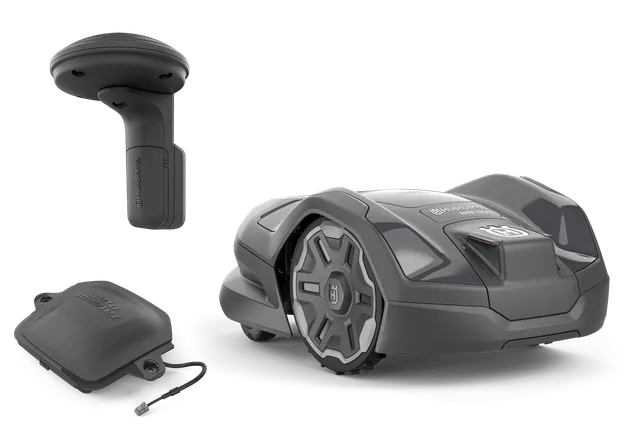 Husqvarna robotic lawn mower with a charging station and a protective cover, studio shot.