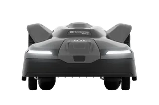 Front view of a Husqvarna robotic lawn mower with LED headlights.