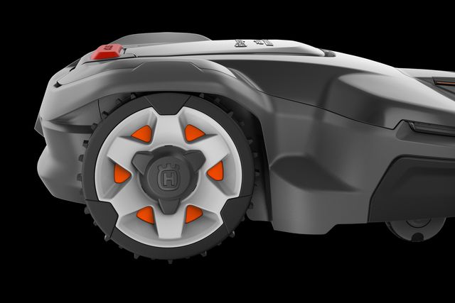 Side view of a robotic lawn mower with distinctive wheel design.
