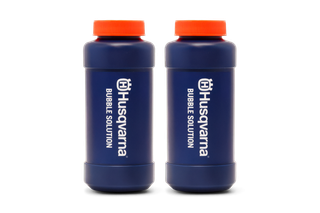 Two bottles of Husqvarna bubble solution with branding visible.