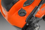 Close-up view of a Husqvarna product showing the fuel cap and part of the wheel.