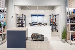 Husqvarnas robotgräsklippare visas i en utställningsmiljö.