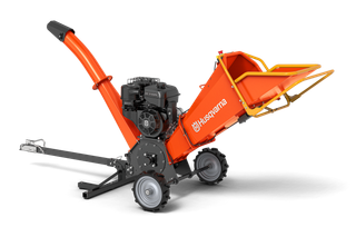 Side view of a garden chipper with a discharge chute and large wheels.