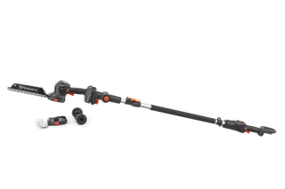 Вид збоку на висоторіз Husqvarna зі змінними насадками на білому тлі.