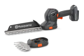 Вигляд спереду акумуляторного тримера для живої огорожі Husqvarna зі змінними лезами.