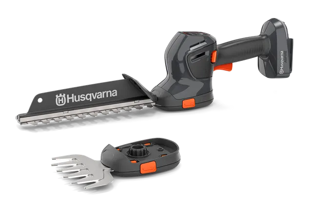 Вигляд спереду акумуляторного тримера для живої огорожі Husqvarna зі змінними лезами.