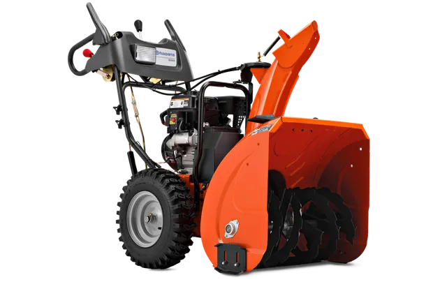 Side view of a snow blower with visible auger and control panel.