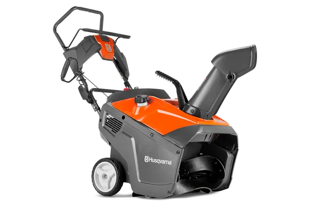 Side view of a Husqvarna snow blower with ergonomic handle and discharge chute.