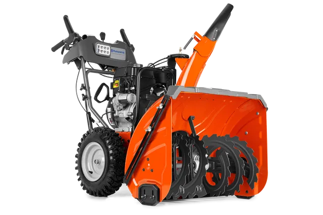 Vue latérale d’une souffleuse à neige Husqvarna avec tarière et panneau de commande visibles.