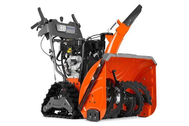 Front view of a Husqvarna snow blower with track drive and auger.