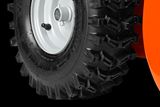 Close-up view of a heavy-duty tire with deep treads, suitable for rugged terrain.