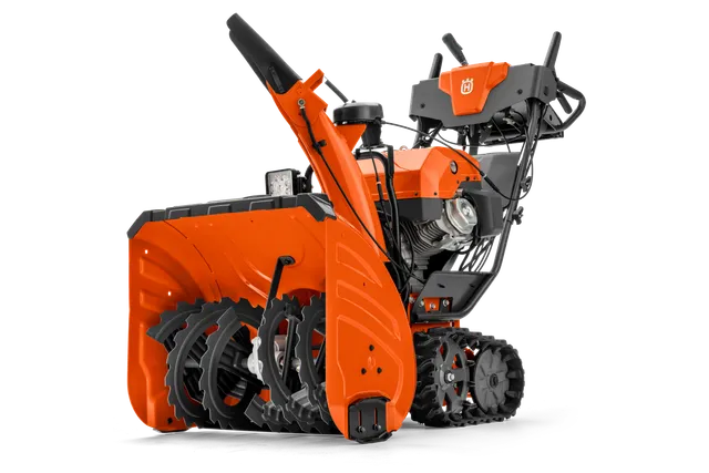 Side view of a Husqvarna snow blower with visible auger and control panel.