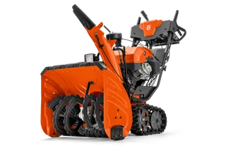 Side view of a Husqvarna snow blower with visible auger and control panel.