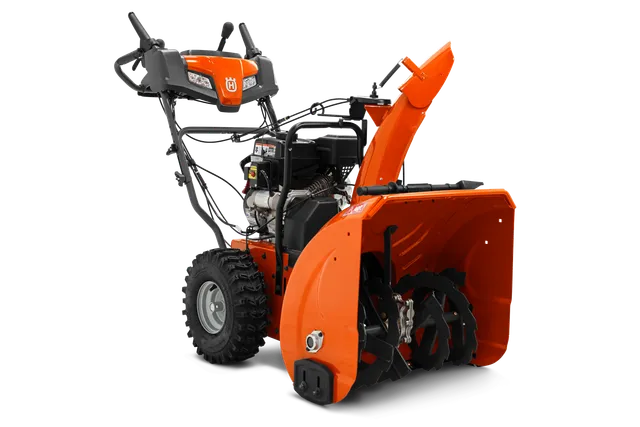 Vue latérale d’une souffleuse à neige Husqvarna avec commandes et tarière visibles.