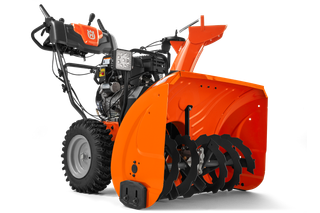 Seitenansicht einer Husqvarna Schneefräse mit sichtbarer Schnecke und Bedienfeld.