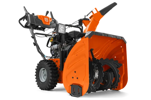 Seitenansicht einer Husqvarna Schneefräse mit sichtbarer Schnecke und Bedienfeld.