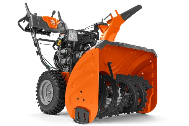 Vue latérale d’une souffleuse à neige Husqvarna mettant en valeur sa tarière et ses commandes.