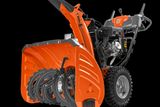 Seitenansicht einer Husqvarna-Schneefräse mit Schnecke und Motor.