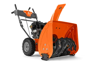 Side view of a Husqvarna snow blower with visible auger and control handles.