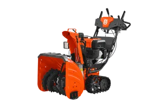 Side view of a Husqvarna snow blower showcasing its auger and control panel.