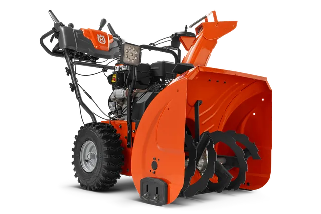 Side view of a Husqvarna snow blower showcasing its auger and control panel.