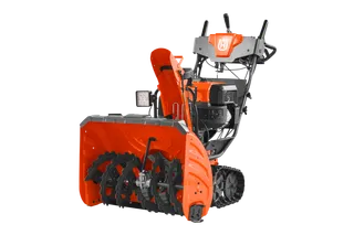 Side view of a Husqvarna snow blower with visible auger and control panel.