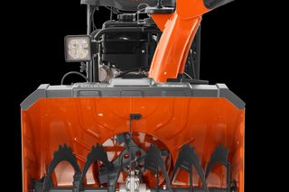 Front view of a Husqvarna snow blower showcasing its auger and chute.