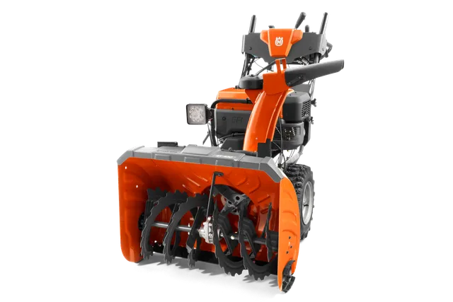 Vue de face d’une souffleuse à neige Husqvarna avec tarière et commandes visibles.