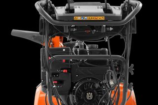 Rear view of a Husqvarna snow blower showing the engine and control panel.