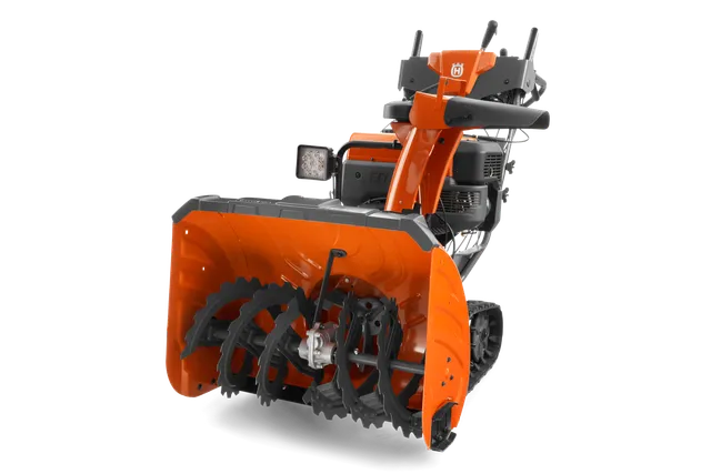 En snöslunga från Husqvarna med snöskruv och kontrollpanel sedda framifrån.