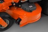 Close-up of a lawn mower's cutting deck and wheels.