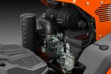 Close-up view of a Kawasaki engine installed in a machine, showcasing its components.