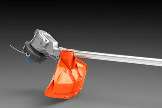 Side view of a string trimmer head with protective guard.