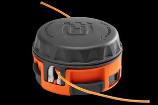 Front view of a Husqvarna trimmer head with visible trimmer line.