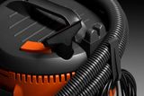 Close-up view of a construction vacuum cleaner with hose and handle.