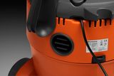 Close-up view of a Husqvarna product with visible ventilation slots and a power cord.