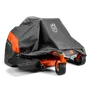 Husqvarna ride-on mower partially covered with a protective cover.
